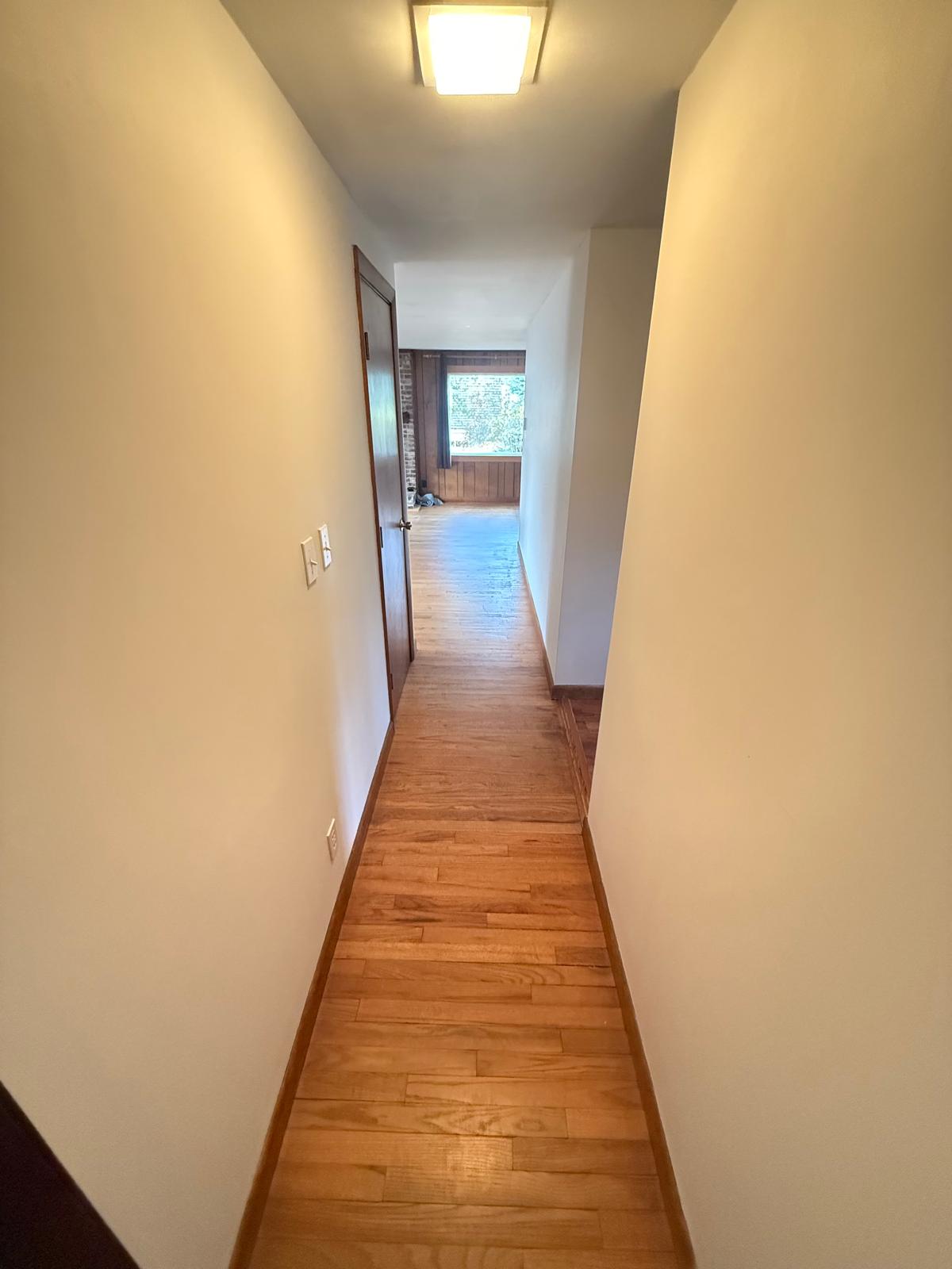 Narrow hallway leading into the original living space