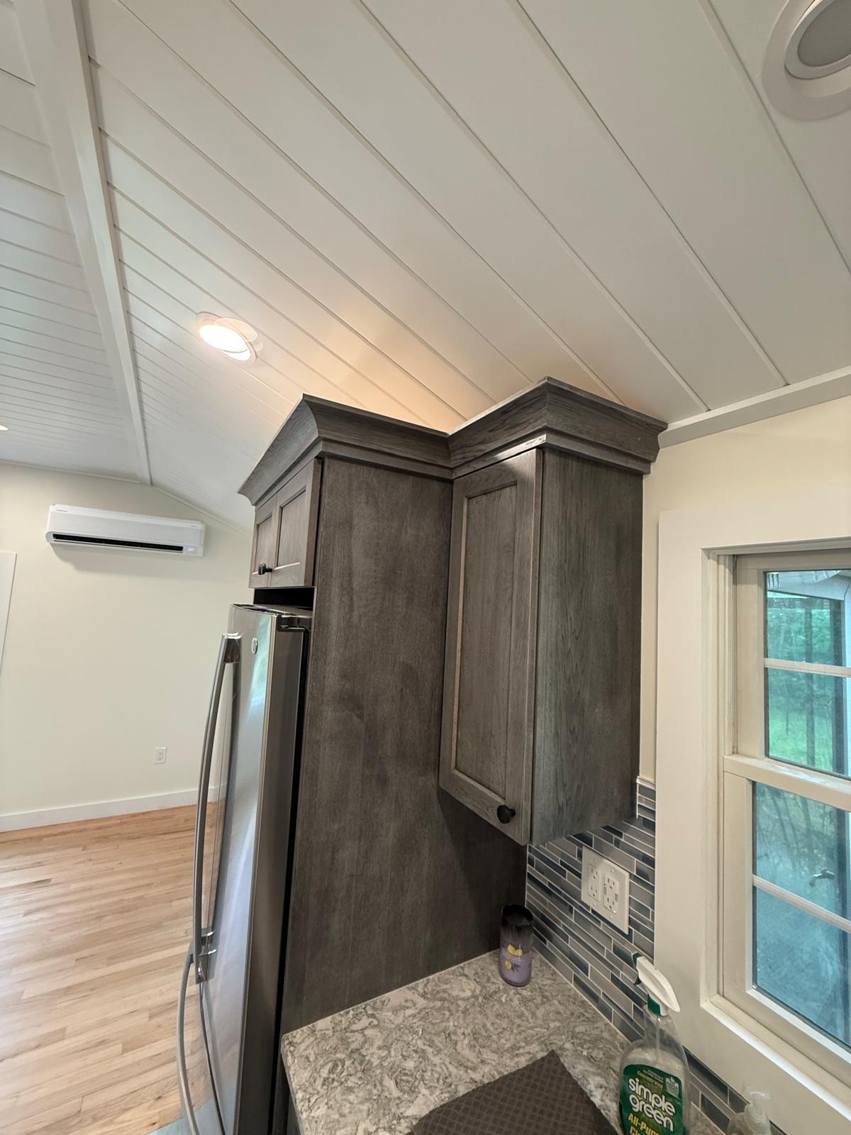 Crown molding detail where cabinetry meets the new shiplap ceiling