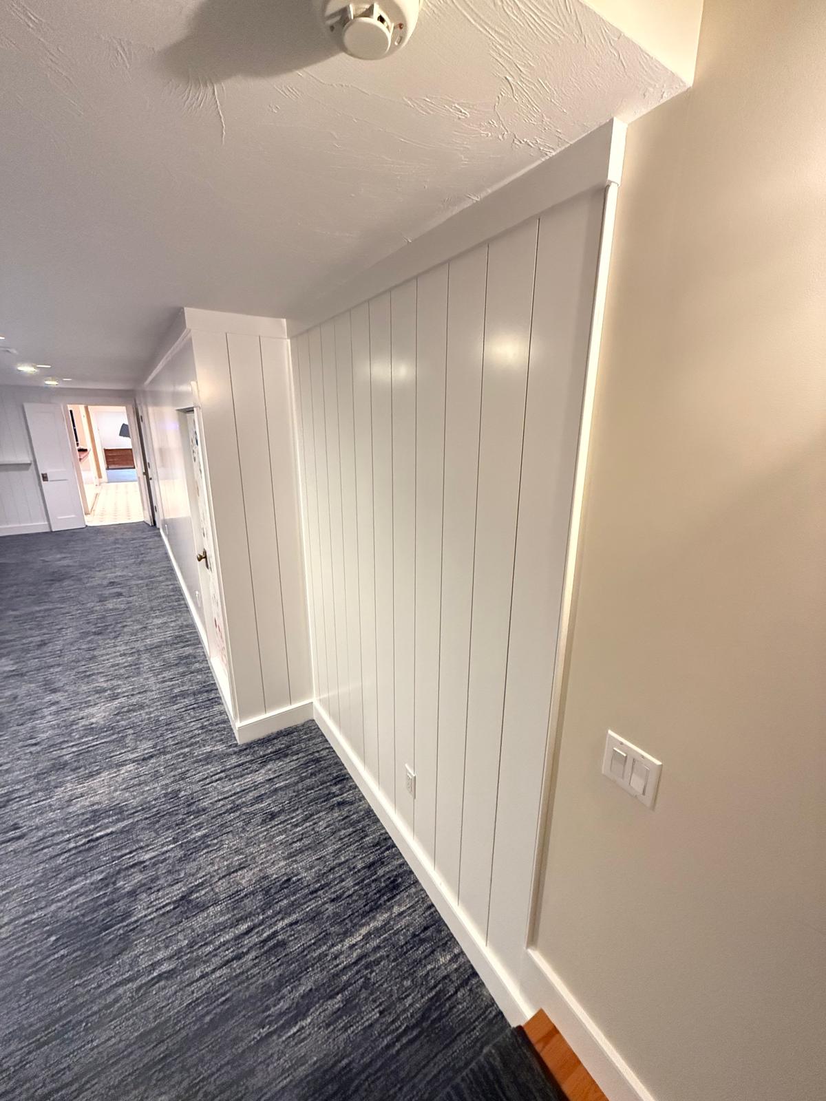 Hallway shiplap accent wall with clean trim reveals
