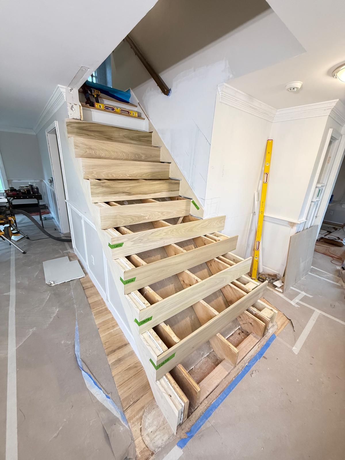 Oak treads being test-fitted on the new stair frame