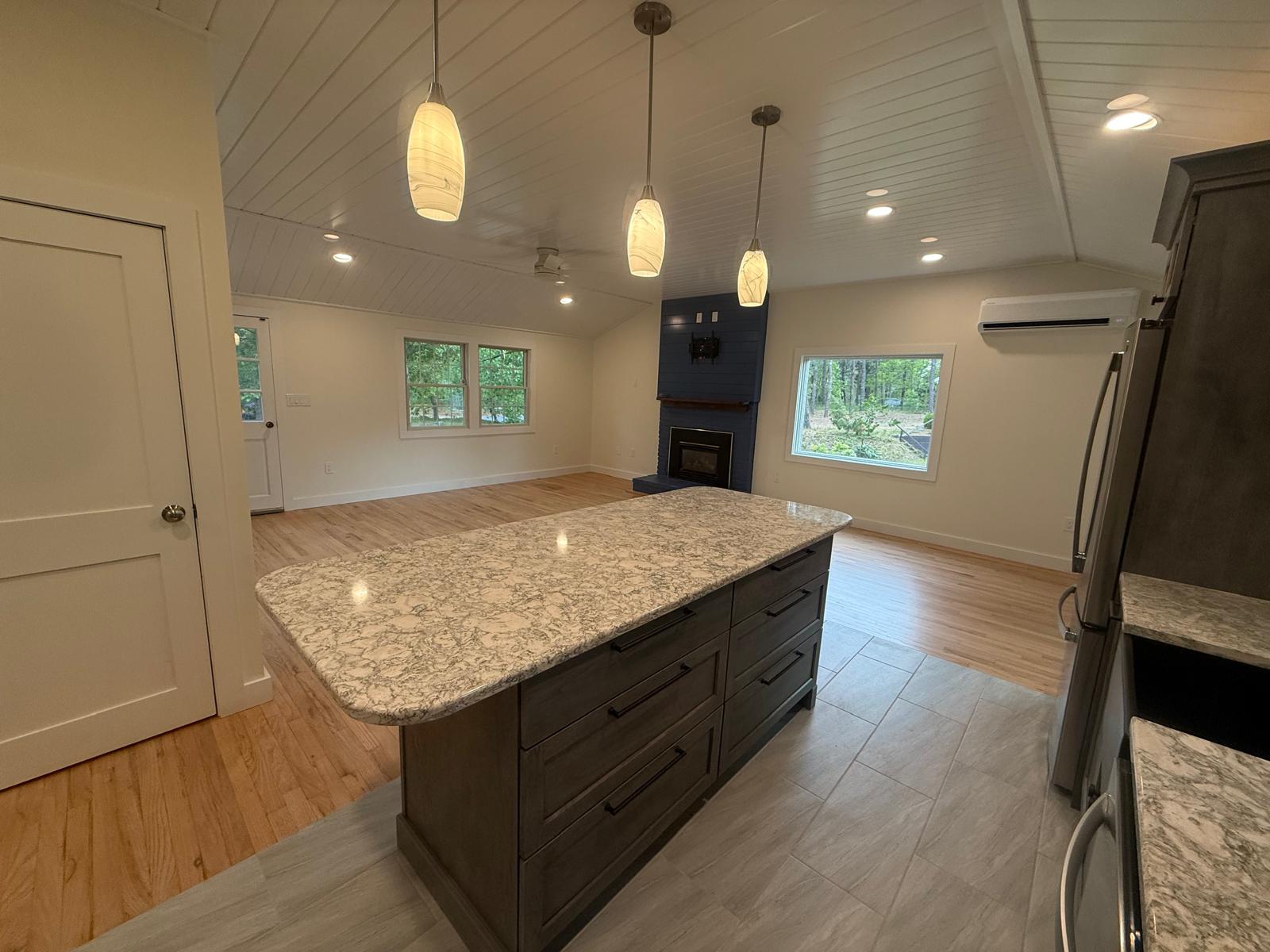 Quartz waterfall island with pendant lighting and tile floor