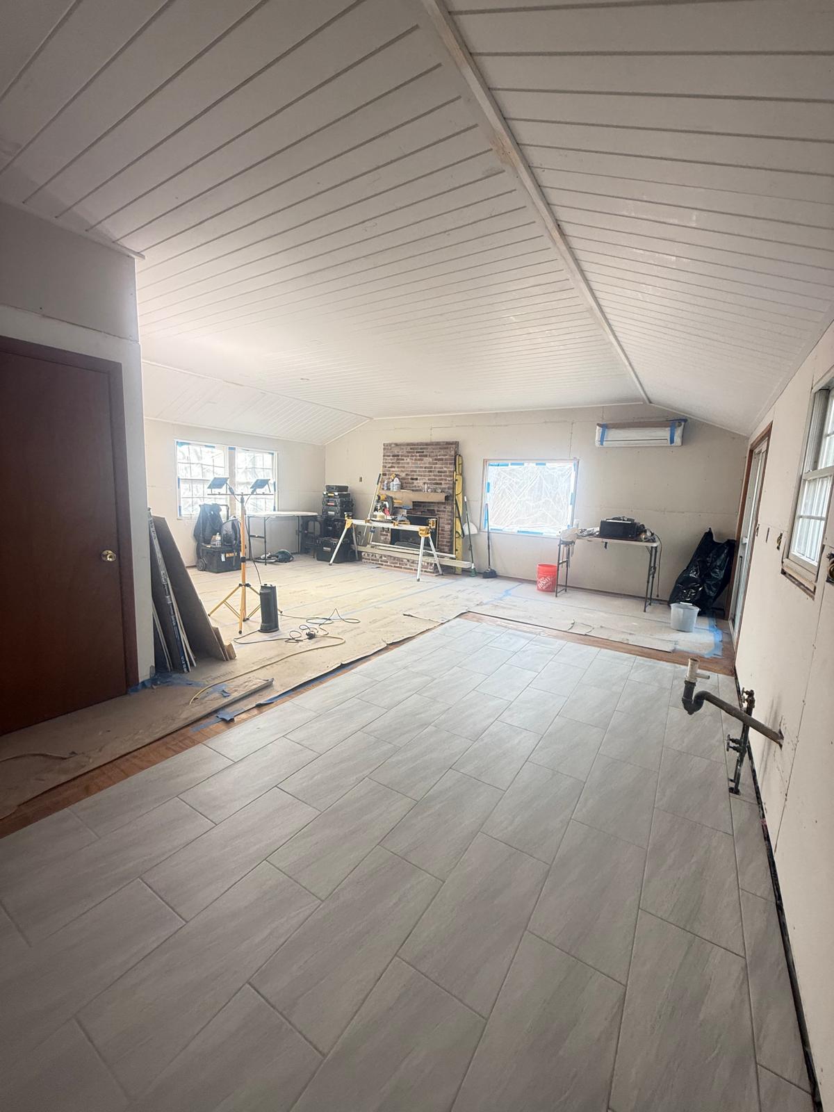 New shiplap wood ceiling and porcelain tile flooring installed