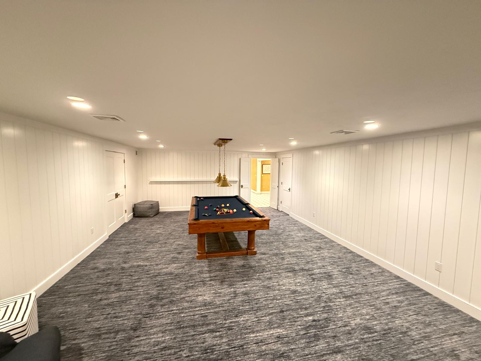 Lounge with full-height shiplap paneling across all walls